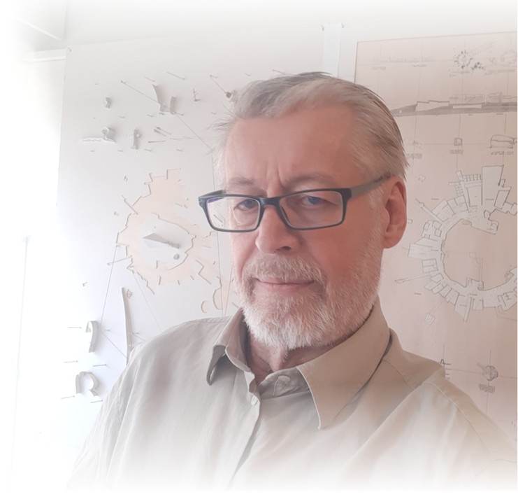 Juhani Risku with white hair, white shirt, mustach, beard and glasses.