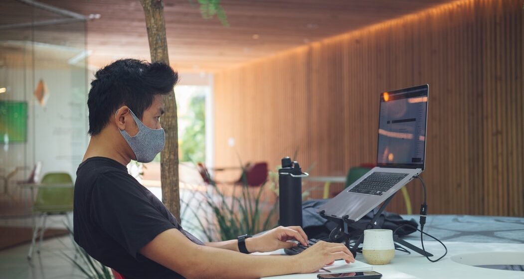 Remote worker with a face mask.