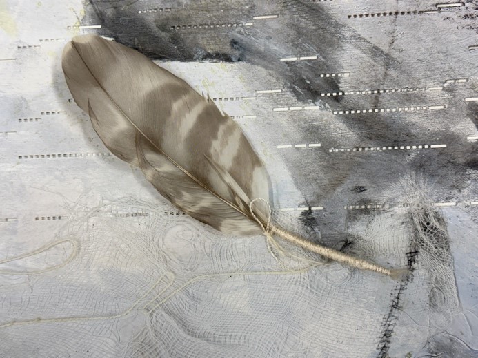Bound feather stuck on pianola scroll