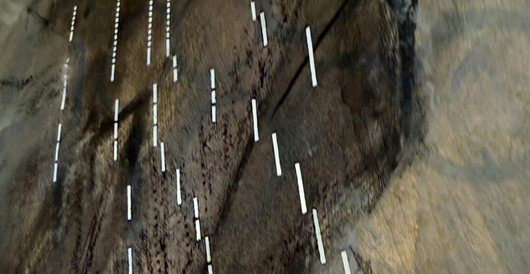 Close up of light coming through pianola scroll holes, looking very digital and mysterious