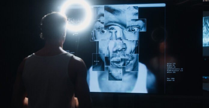 Actor Samuel Kujala looking at his AI-generated image on the screen of Modern Mythologies