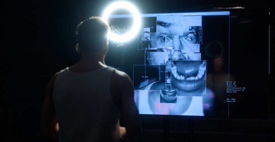 Image of Samuel Kujala performing Modern Mythologies in from of a warped AI moving image of Samuel